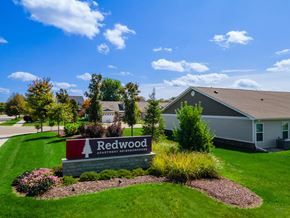 Superior Township apartment for rent - A sign for Redwood Apartment Homes is in front of a building.