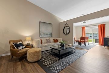 Superior Township apartment for rent - A living room with a brown chair and a black coffee table.
