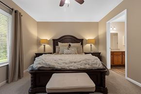 Sylvania apartment for rent - A bedroom with a large bed and a ceiling fan.