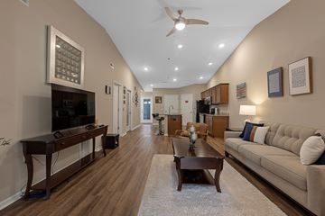 Temperance apartment for rent - A living room with a brown couch and a wooden coffee table.