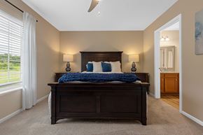 Temperance apartment for rent - A bedroom with a large bed and a ceiling fan.