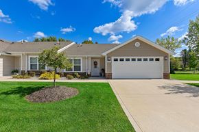 Kalamazoo apartment for rent - A house with a brown roof and a white garage door.