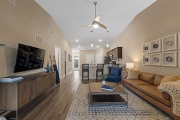 Troutman apartment for rent - A living room with a brown couch and a coffee table.
