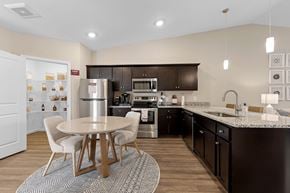 Troy apartment for rent - A modern kitchen with a table and chairs.