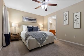 Union Township apartment for rent - A bedroom with a bed, nightstand, and a ceiling fan.