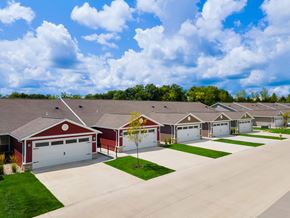 Dayton apartment for rent - A row of houses with garages and driveways.