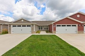 Dayton apartment for rent - A two-story house with a red brick exterior and a large front yard.