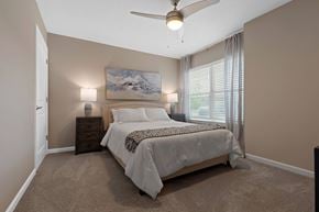 Dayton apartment for rent - A bedroom with a large bed and a painting on the wall.