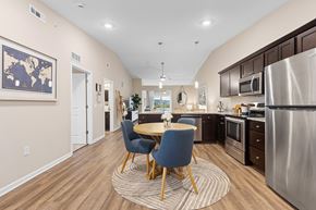 Volo apartment for rent - A kitchen with a table and chairs in the middle of the room.