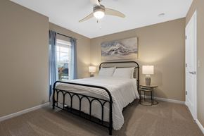 Volo apartment for rent - A bedroom with a large bed and a ceiling fan.