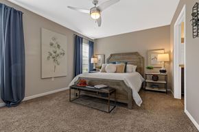Warsaw apartment for rent - A bedroom with a bed, nightstands, and a ceiling fan.