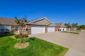 Washington Township apartment for rent - A house with a garage and a tree in the front yard.