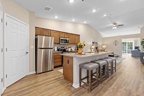 Washington Township apartment for rent - A kitchen with a bar stool and a fridge.