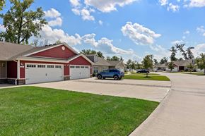 Washington Township apartment for rent - A blue car is parked in front of a red garage.