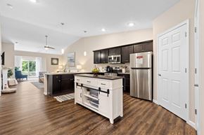 Washington Township apartment for rent - A modern kitchen with dark brown cabinets and white appliances.