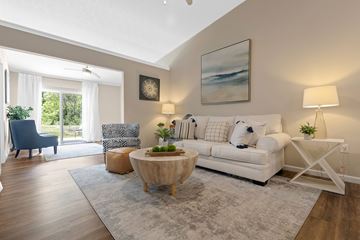 Washington Township apartment for rent - A living room with a white couch, a wooden coffee table, and a painting on the wall.