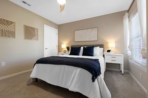 Washington Township apartment for rent - A bedroom with a white bed and a white nightstand.