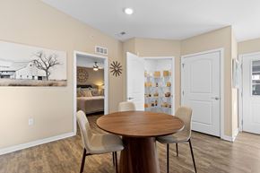 Waukee apartment for rent - A dining room with a wooden table and chairs.