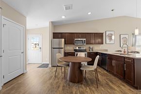 Waukee apartment for rent - A kitchen with brown cabinets and a white fridge.