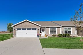 Waukee apartment for rent - A house with a grey roof and a white garage door.