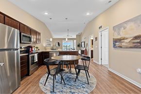 Waukee apartment for rent - A kitchen with a table and chairs in the middle of the room.