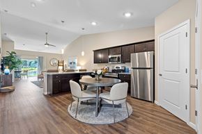 West Jefferson apartment for rent - A modern kitchen with a dining table and chairs in the middle of the room.