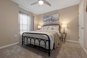 West Jefferson apartment for rent - A bedroom with a large bed and a painting on the wall.