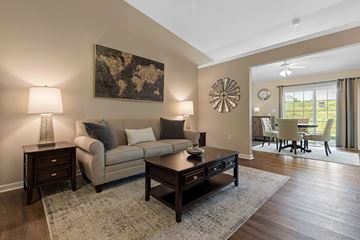 Westfield apartment for rent - A living room with a beige couch, a coffee table, and a large painting on the wall.