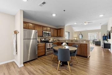 Wolverine Lake apartment for rent - A kitchen with a table and chairs in the middle.