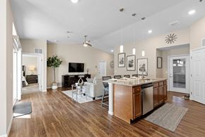 Ypsilanti apartment for rent - A modern kitchen with wooden floors and a central island.