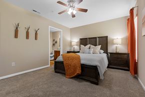 Zeeland apartment for rent - A bedroom with a bed, nightstands, and a ceiling fan.