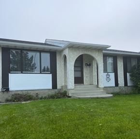 Edmonton apartment for rent - A house with a white garage door and a brown door.