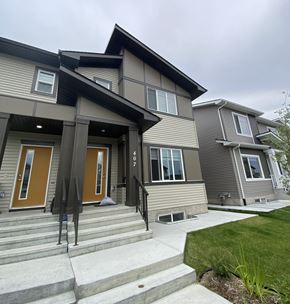 Leduc apartment for rent - A modern house with a brown door and a grey facade.