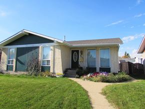 Edmonton apartment for rent - A house with a green door and a brown roof.