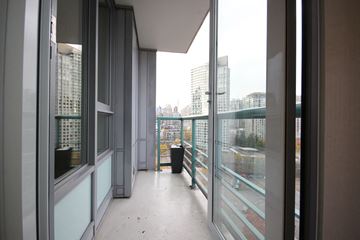 Vancouver apartment for rent - A balcony with glass railings and a view of the city.