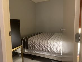 Vancouver apartment for rent - a bedroom with a bed and a wardrobe