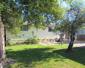 Edmonton apartment for rent - A tree is in front of a house.