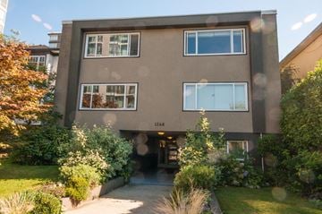 Vancouver apartment for rent - the front of a building with a sidewalk and a yard