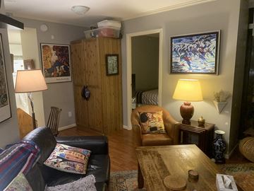 Vancouver apartment for rent - A living room with a couch, chair, and lamp.