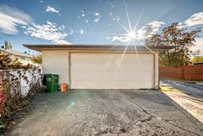 Edmonton apartment for rent - A garage with a white door is under a bright sun.