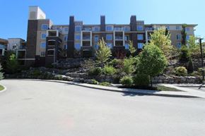 Kelowna condo for rent - A large building with a lot of windows and balconies.