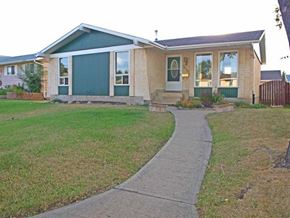 Edmonton apartment for rent - A house with a green door and a grey roof.