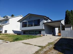 West Kelowna apartment for rent - A two-story house with a garage and a driveway.