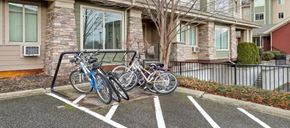 Kelowna condo for rent - Two bicycles are parked in a parking spot.