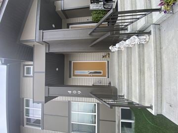 Leduc apartment for rent - A modern building with a balcony and a window.