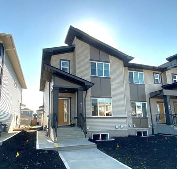 Leduc apartment for rent - A modern house with a front yard and a clear sky.