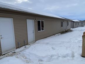 Leduc triplex for rent - A line of houses with snow on the roofs and ground.