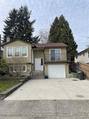 Coquitlam apartment for rent - a house with a driveway and a white garage door