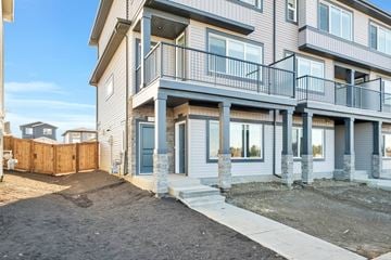 Leduc triplex for rent - A multi-story residential building with a balcony on the second floor.