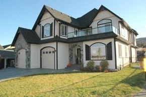 Kelowna apartment for rent - A large two-story house with a balcony on the second floor.